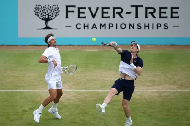 Andy Murray's partner Feliciano Lopez watches as the Scot fires a smash during their match against Dan Evans and Ken Skupski. Picture: Alex Pantling/Getty Images
