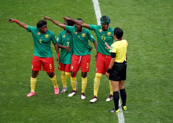 Cameroon players appeal to referee Qin Liang after England's second goal was given by VAR after an offside call. Picture: John Walton/PA Wire