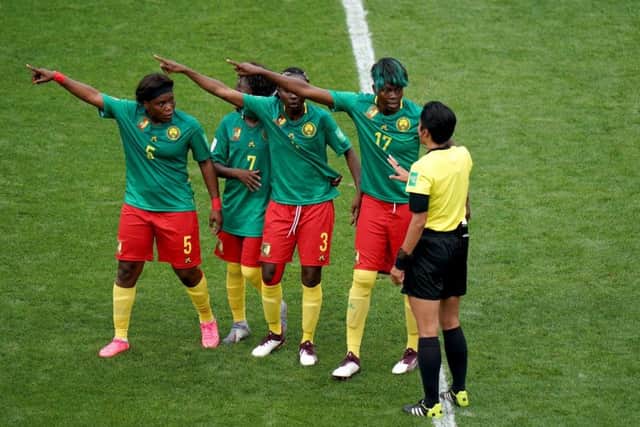 Cameroon players appeal to referee Qin Liang after England's second goal was given by VAR after an offside call. Picture: John Walton/PA Wire