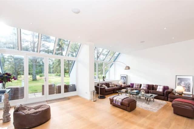 The spacious living room benefits from floor to ceiling windows.