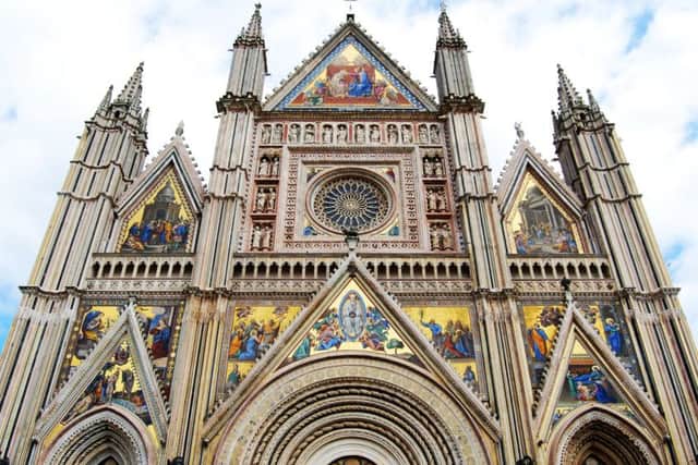 The facade of the cathedral with its carvings, mosaic and rose window