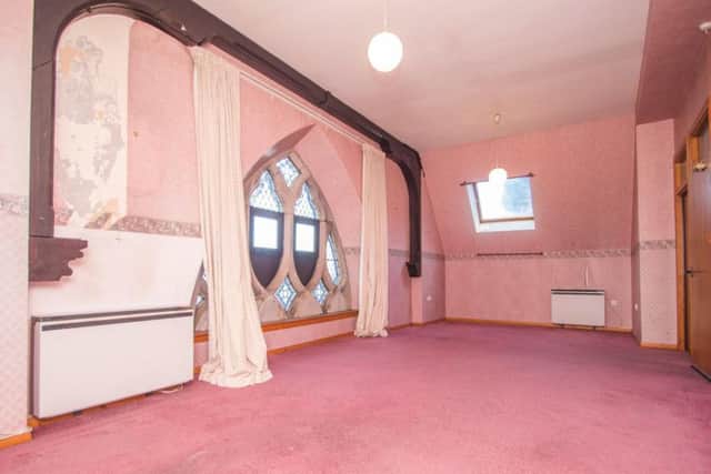 The living room has the original stained glass window.