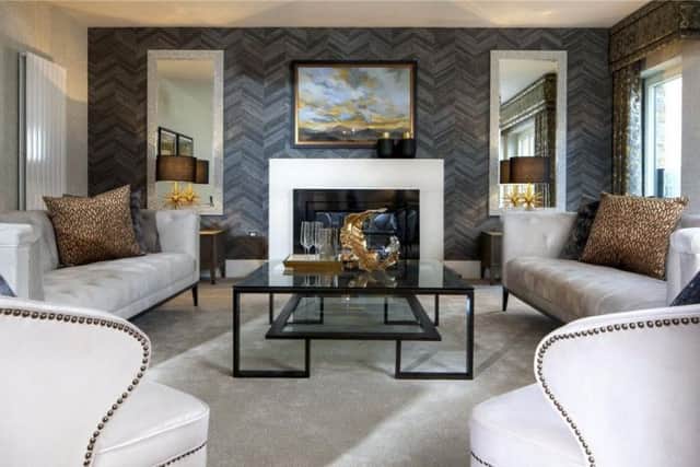 The living room has a feature fireplace and eye-catching wallpaper.