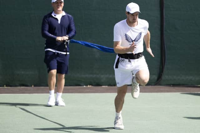 Andy Murray warms up before a training session at Wimbledon. Picture: Peter Klaunzer/Keystone via AP