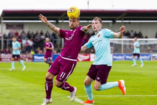 Hearts' Lewis Moore, right, challenges Bobby Linn of Arbroath. Picture: SNS