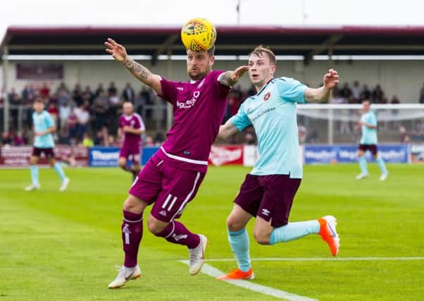 Hearts' Lewis Moore, right, challenges Bobby Linn of Arbroath. Picture: SNS