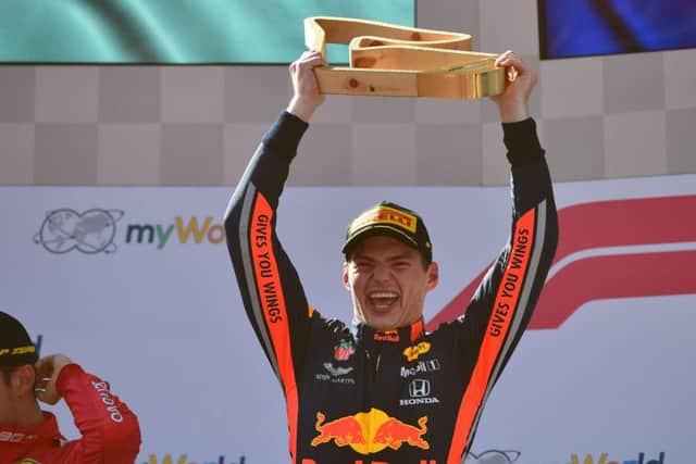 Max Verstappen celebrates on the podium following his victory in the austrian Grand Prix, though he has to wait another three hours before FIA officials confirmed the win. Picture: AFP/Getty.