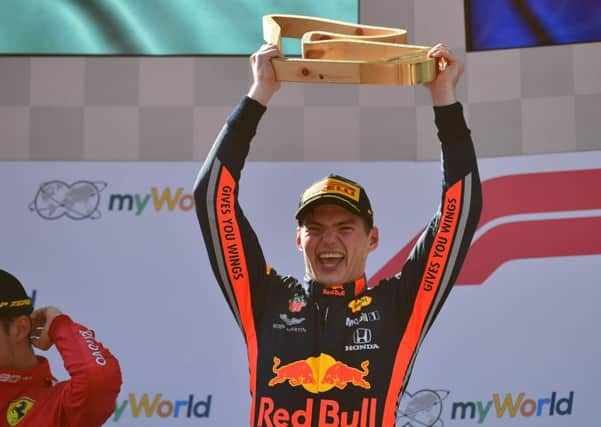 Max Verstappen celebrates on the podium following his victory in the austrian Grand Prix, though he has to wait another three hours before FIA officials confirmed the win. Picture: AFP/Getty.