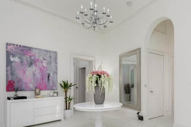 Although a period property, the interior is modern with marble floors and white walls.