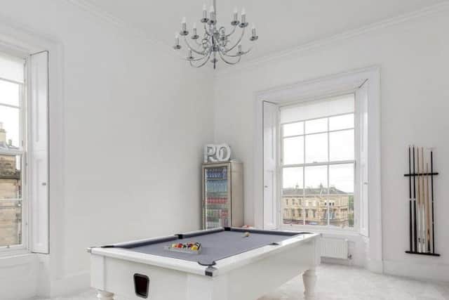 The contemporary games room also has a neutral/white colour scheme.