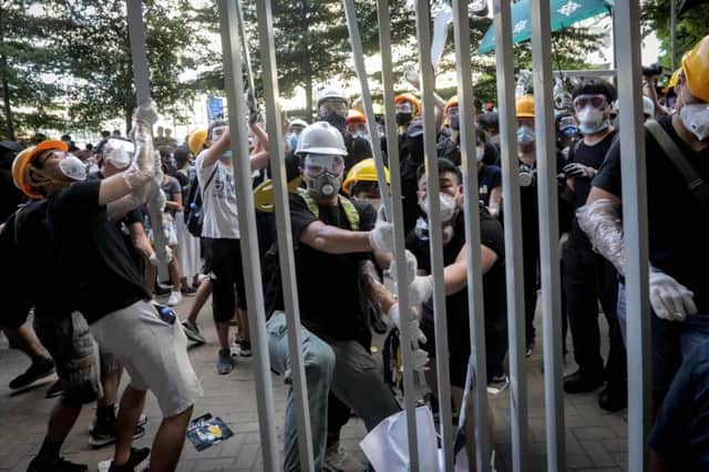 Protesters attempt to break into the government headquarters in Hong Kong on July 1, 2019, on the 22nd anniversary of the city's handover from Britain to China. (Photo by VIVEK PRAKASH / AFP)VIVEK PRAKASH/AFP/Getty Images