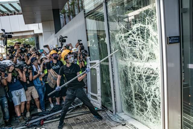 Protesters smash glass doors and windows of the Legislative Council Complex on July 1, 2019 in Hong Kong, China. (Photo by Anthony Kwan/Getty Images)