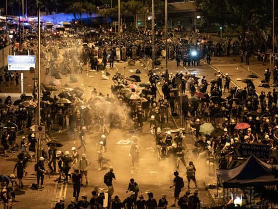 Police fire tear gas as they charge toward protesters outside the Legislative Council Complex. Picture Anthony Kwan / Getty Images.