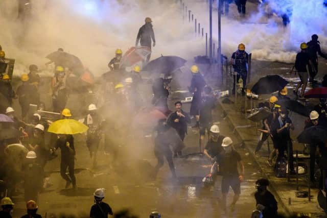 Police fire tear gas at protesters near the government headquarters in Hong Kong. Picture: Anthony Wallace / AFP
