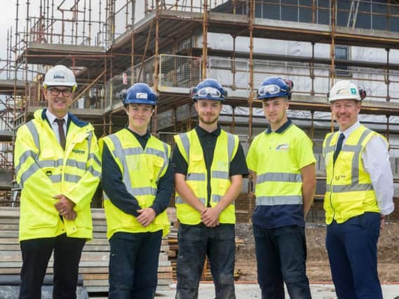 Construction director Neil Thomson (left) on site with workers from Stewart Milne Homes North. Picture: Contributed