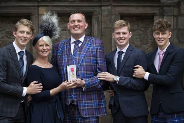 Former Scotland rugby international and motor neurone disease campaigner Doddie Weir, with wife Kathy and their three sons (from left) Hamish, Ben and Angus, after receiving his OBE from Queen Elizabeth (Picture: Jane Barlow/PA Wire)