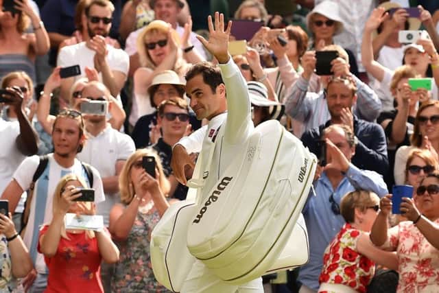 Roger Federer salutes the fans after his first-round victory.