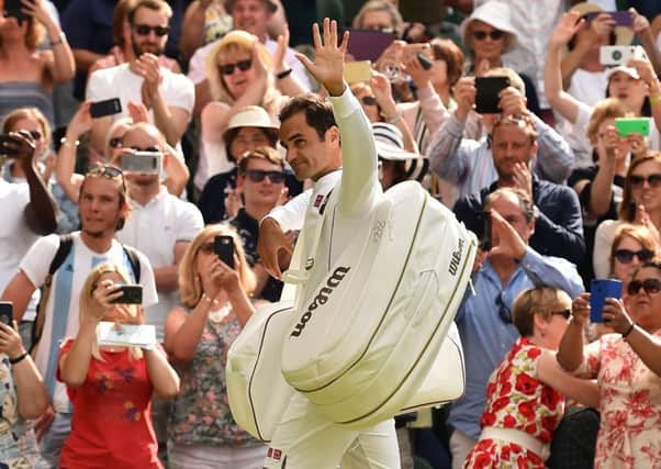 Roger Federer salutes the fans after his first-round victory.