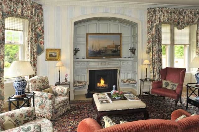 The living room has an original fireplace and cornicing.