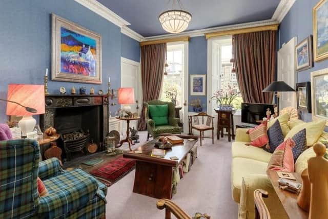 Period features in the living room include an ornate fireplace, shutters and cornicing.