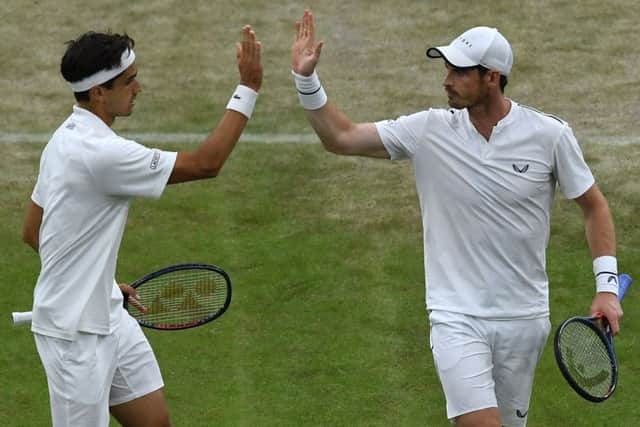 Andy Murray, right, celebrates with doubles partner Pierre-Hugues Herbert. Picture: Ben Stansall/AFP/Getty Images