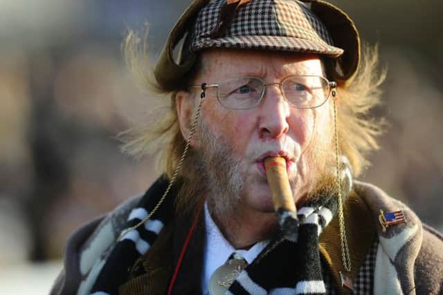 John McCririck, with his trademark deerstalker and cigar. The journalist and broadcaster has died at the age of 79