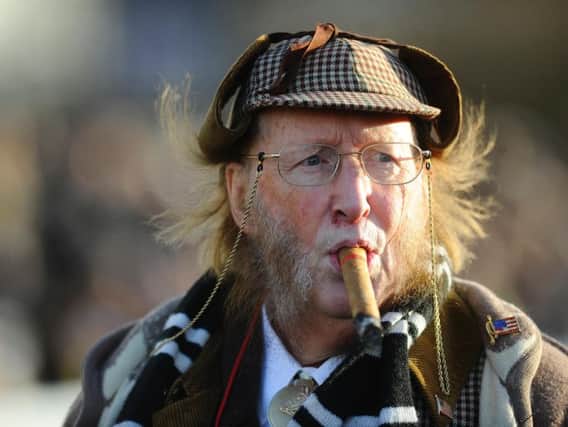 John McCririck, with his trademark deerstalker and cigar. The journalist and broadcaster has died at the age of 79