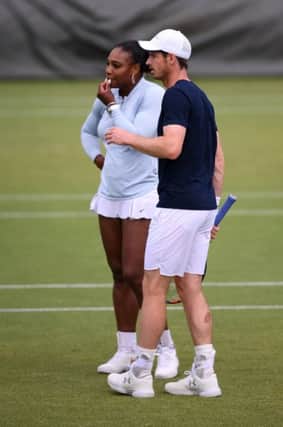 Andy Murray and mixed doubles partner Serena Williams discuss tactics during a practice session at Wimbledon yesterday. Picture: Laurence Griffiths/Getty Images
