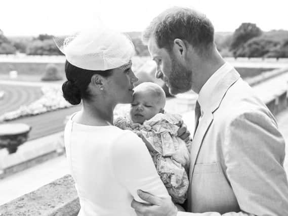 Prince Harry, Duke of Sussex and Meghan, Duchess of Sussex pose with their son, Archie Mountbatten-Windsor with the Rose Garden in the background at Windsor Castle. (Photo by Chris Allerton/SussexRoyal via Getty Images)
