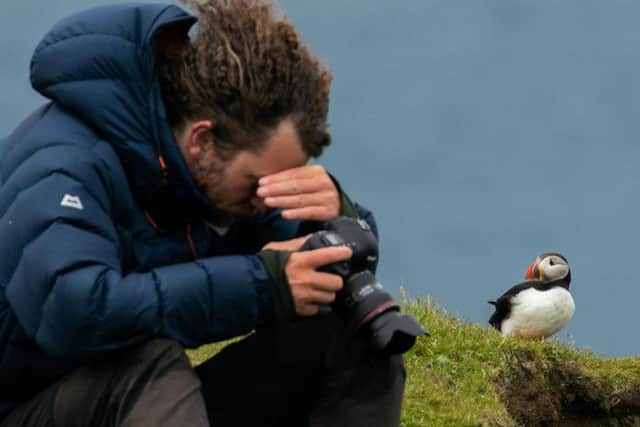 Photographer Adam Gray, 32, was visiting from London when he snapped the Atlantic puffins flying inland. Picture: SWNS