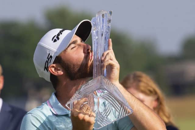 Matthew Wolff kisses the trophy after winning the 3M Open. Picture: Andy Clayton/AP