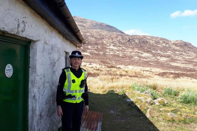 PC Samantha Briggs at the bothy at Tunskeen in the Galloway Forest Park. Patrols at bothies across southern Scotland will be stepped up following reports of parties, anti-social behaviour and fires at the simple properties which are used as shelters for hillwalkers. PIC: Contributed.
