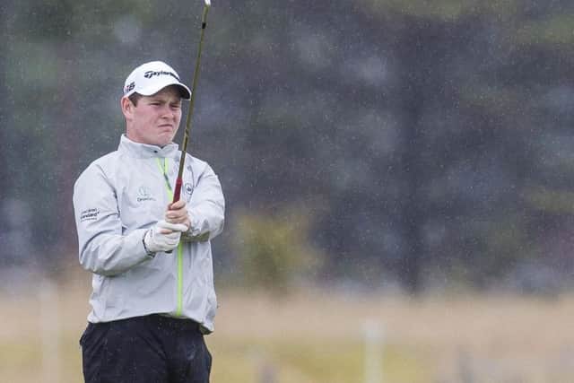 Robert MacIntyre practises in the rain. Picture: Bruce White/SNS