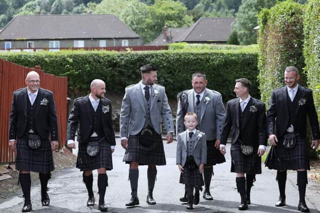 Jack with his dad Michael and the groomsmen. Picture: SWNS
