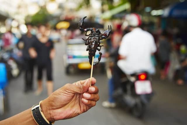 Street food in Thailand includes roasted scorpion