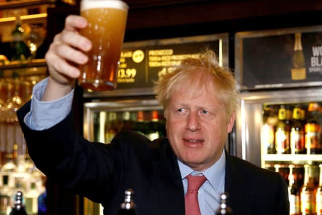 Boris Johnson holds up a beer as he meets JD Wetherspoon chair and Brexit fan Tim Martin (Picture: Henry Nicholls WPA Pool/Getty Images)