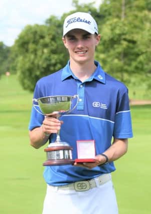 Cameron Adam shows off the trophy after his win on home turf at Royal Burgess. Picture: Scottish Golf