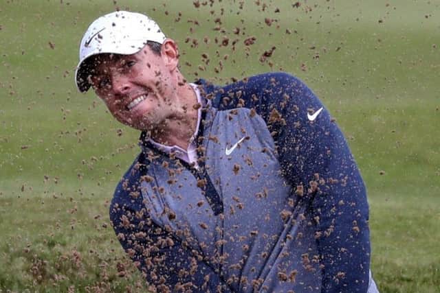 Rory McIlroy plays out a bunker at the 12th hole. Picture: Jane Barlow/PA Wire