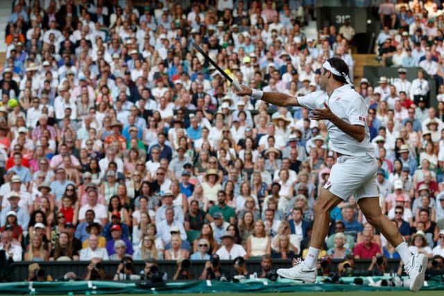 Roger Federer fires another booming forehand back at Rafael Nadal on Centre Court