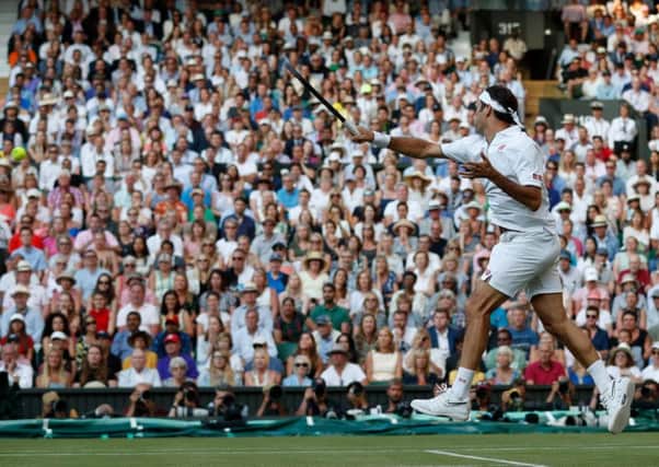 Roger Federer fires another booming forehand back at Rafael Nadal on Centre Court