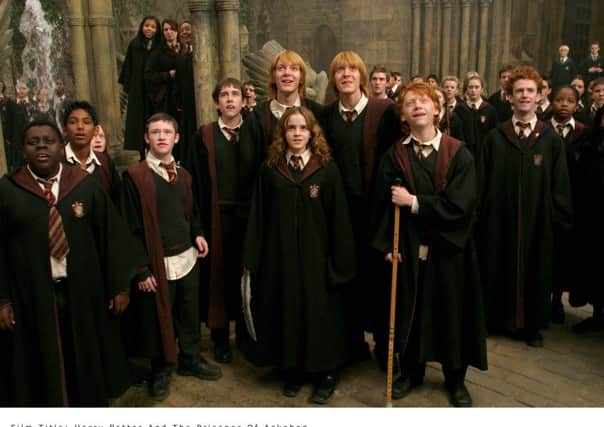 DEVON MURRAY as Seamus Finnegan, MATTHEW LEWIS as Neville Longbottom, OLIVER PHELPS as George Weasley, EMMA WATSON as Hermione Granger, JAMES PHELPS as Fred Weasley, RUPERT GRINT as Ron Weasley and CHRIS RANKIN as Percy Weasley in a scene from Harry Potter and the Prisoner of Azkaban.
