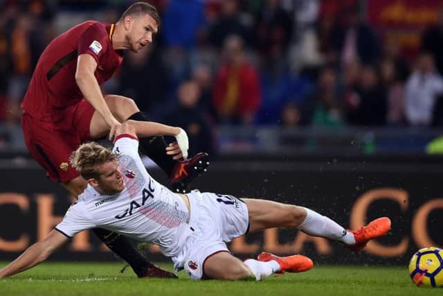 Helander clears the ball as Roma forward Edin Dzeko lurks