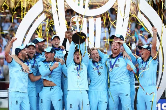 England skipper Eoin Morgan lifts the World Cup surrounded by his jubilant team-mates at Lord's. Picture: Michael Steele/Getty Images