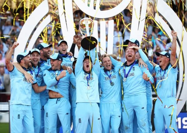 England skipper Eoin Morgan lifts the World Cup surrounded by his jubilant team-mates at Lord's. Picture: Michael Steele/Getty Images