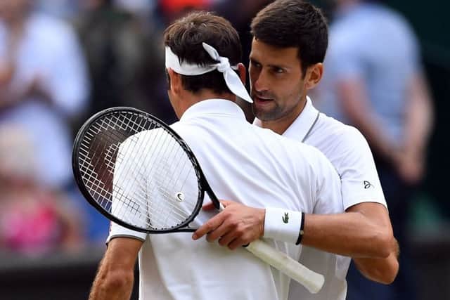 Novak Djokovic, right, and Roger Federer embrace after yesterdays dramatic final