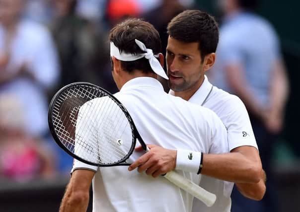 Novak Djokovic, right, and Roger Federer embrace after yesterdays dramatic final