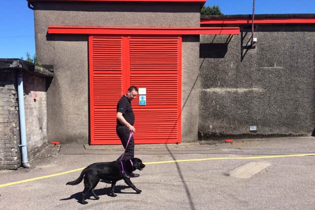 Distillery manager Alistair Longwell walking distillery dog Hebe.