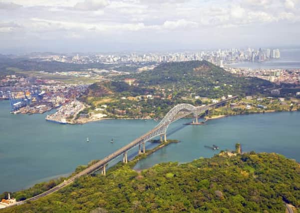 An aerial view of the Bridge of the Americas at the Pacific entrance to the Panama Canal with Panama City in the background