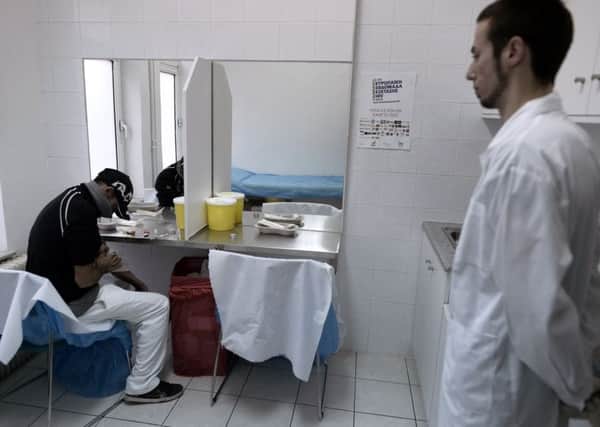 An addict prepares to use a drug consumption room in Greece (Picture: Aris Messinis/AFP/Getty Images)