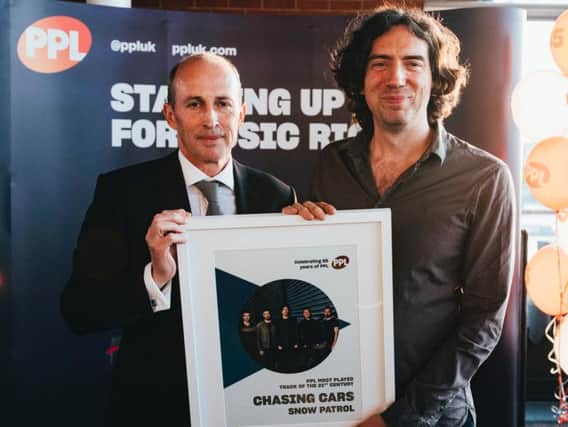 Gary Lightbody from Snow Patrol being presented the award by Peter Leathem, Chief Executive Officer at PPL.